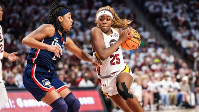 Feb 11, 2024; Columbia, South Carolina, USA; South Carolina Gamecocks guard Raven Johnson (25) drives around UConn Huskies guard KK Arnold (2) in the first half at Colonial Life Arena. 